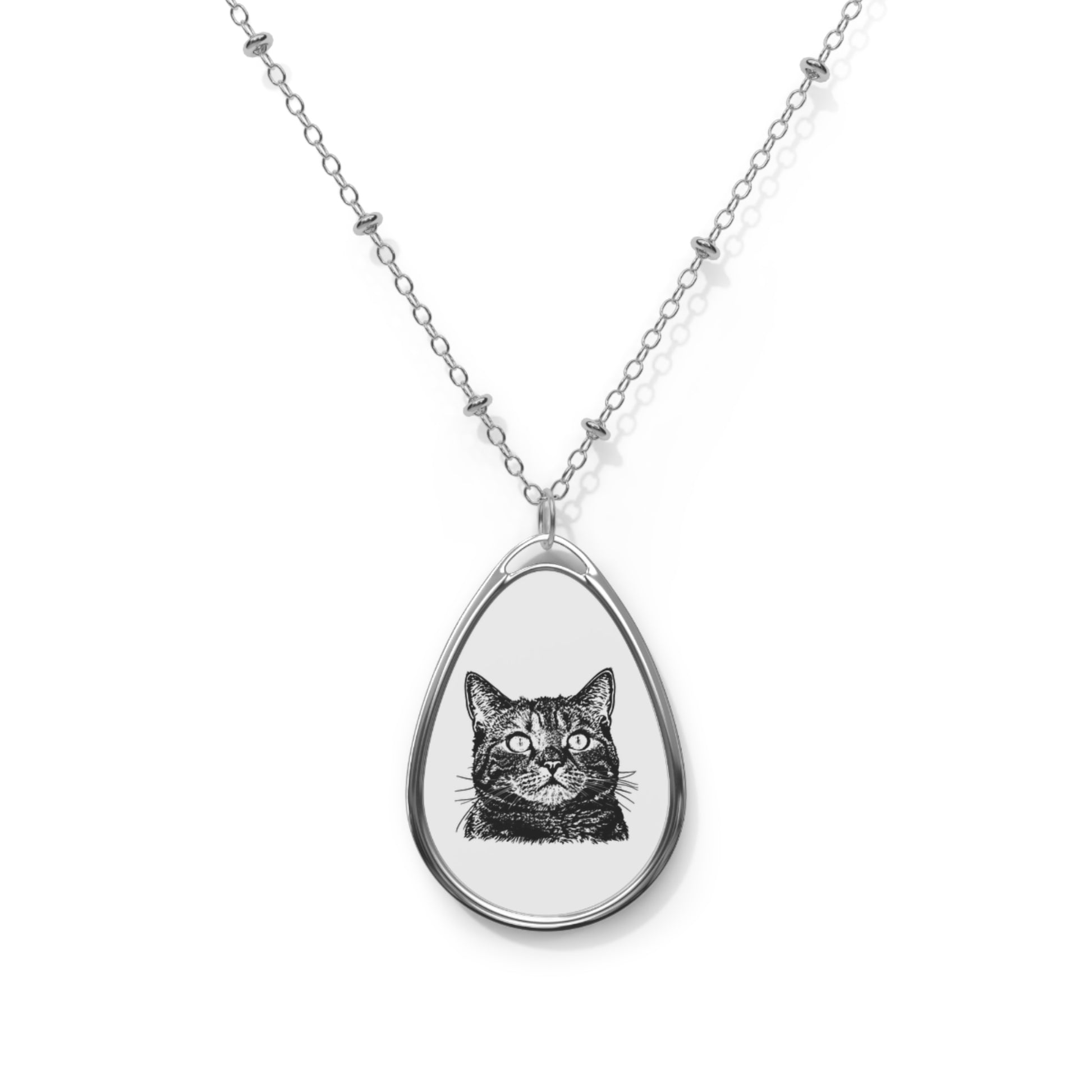Teardrop-shaped pendant with a cat illustration on a white chain against a white background