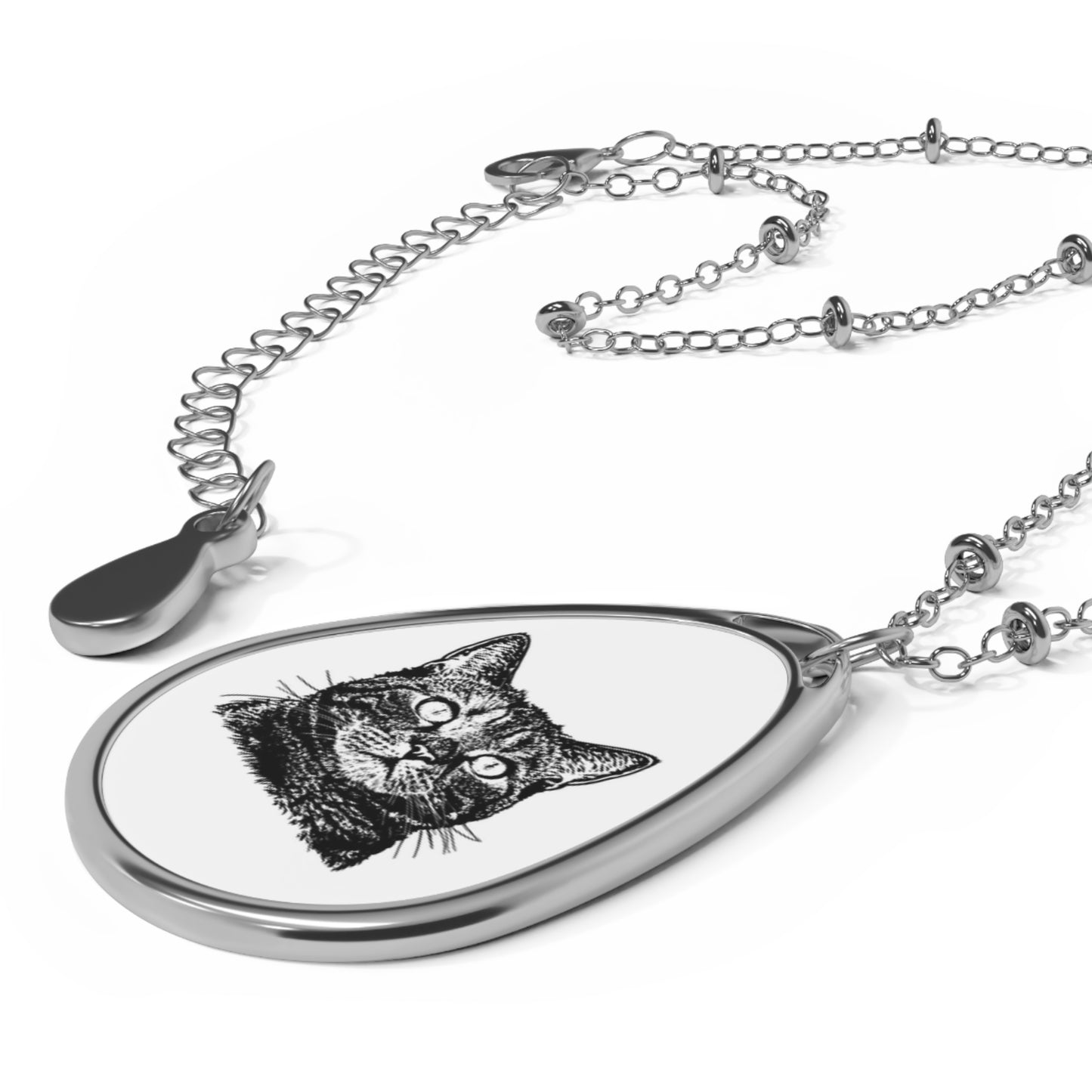 Teardrop-shaped pendant with a cat illustration on a white background