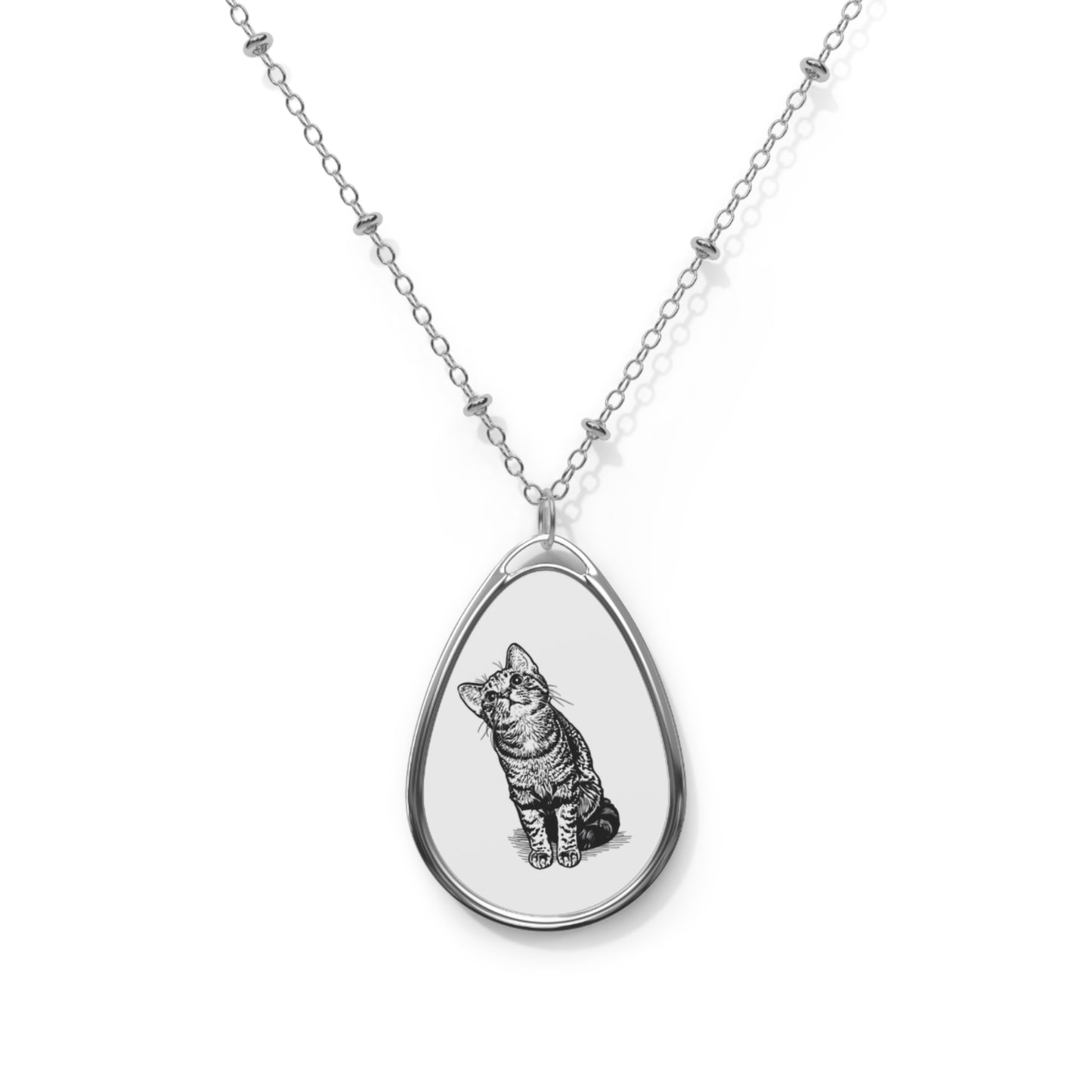 Teardrop-shaped pendant with a cat illustration on a white background