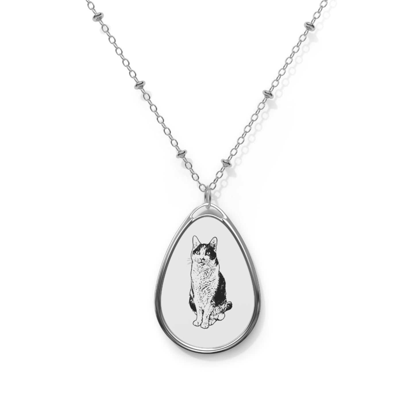 Teardrop-shaped pendant with a cat illustration on a white background