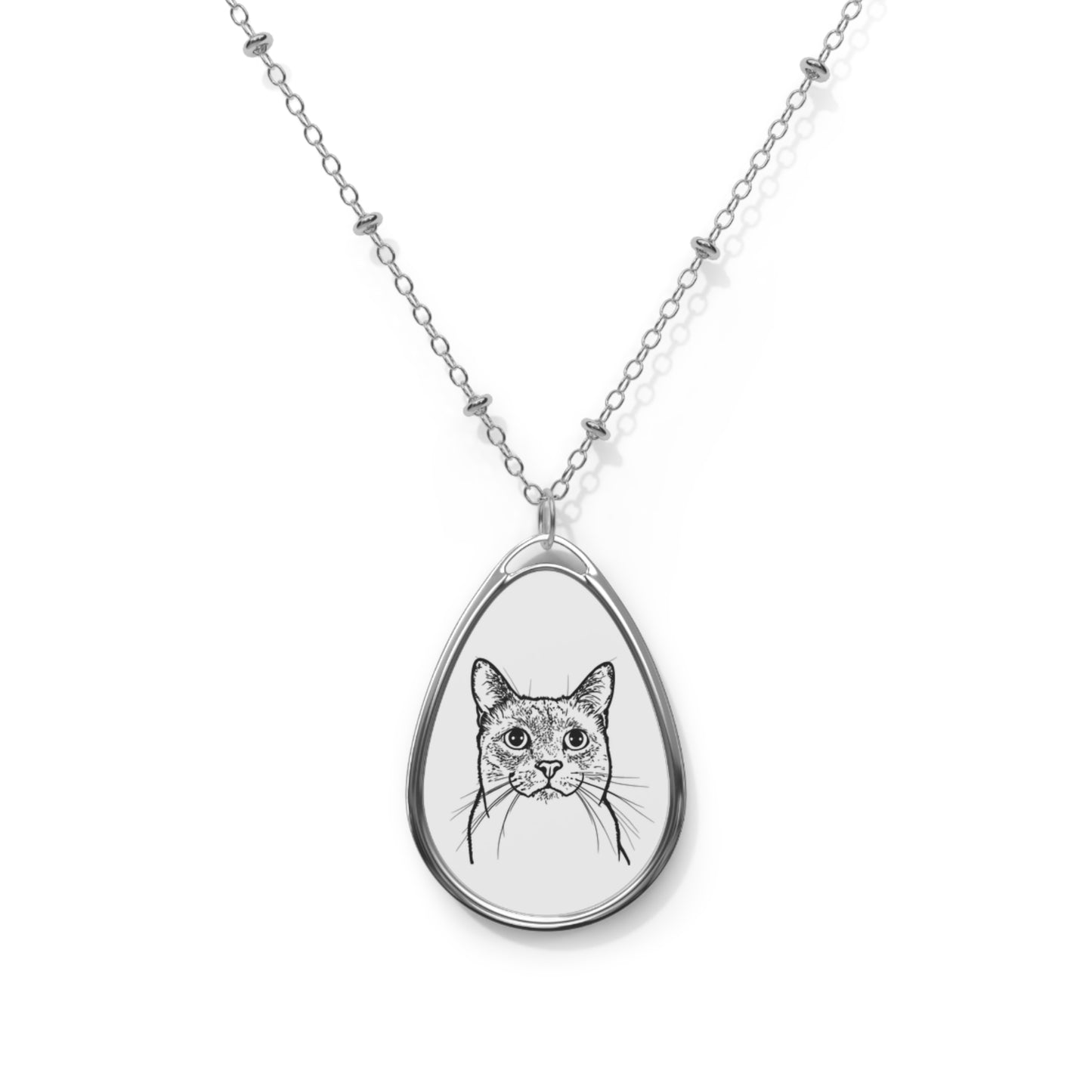 Teardrop-shaped pendant with a cat illustration on a white chain against a white background