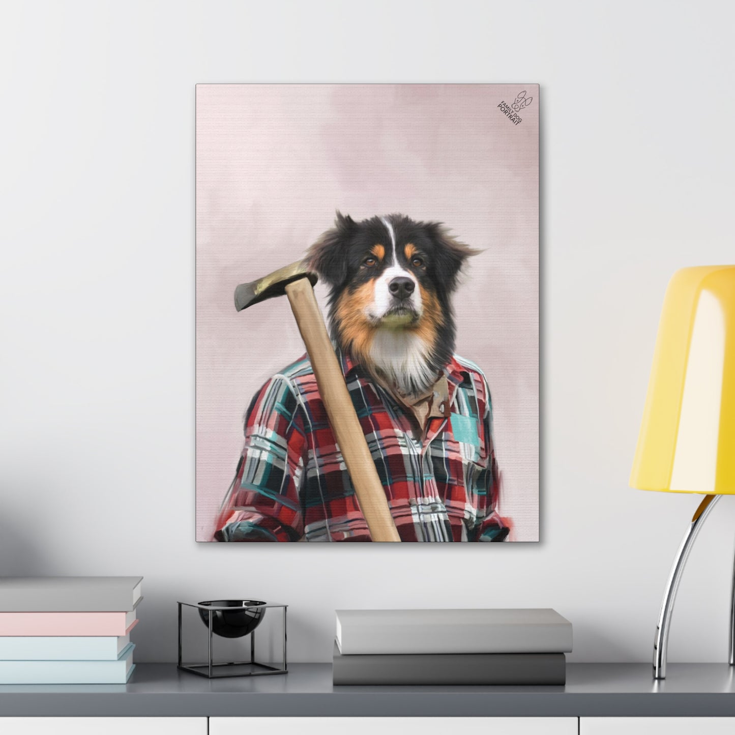 Canvas print of a dog wearing a plaid shirt with a hammer, displayed on a wall above a desk.
