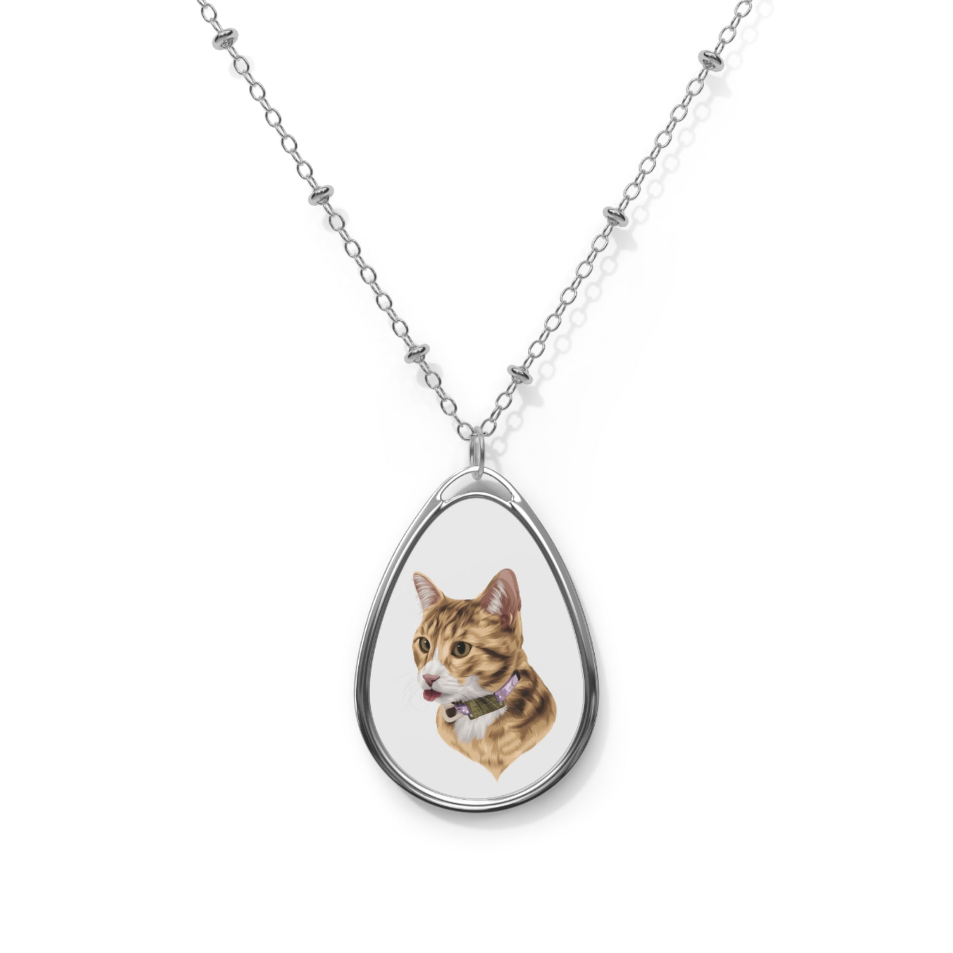 Close-up of a cat portrait on a white aluminum oval pendant