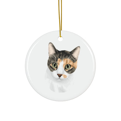Round ceramic ornament with a cat's face on a white background