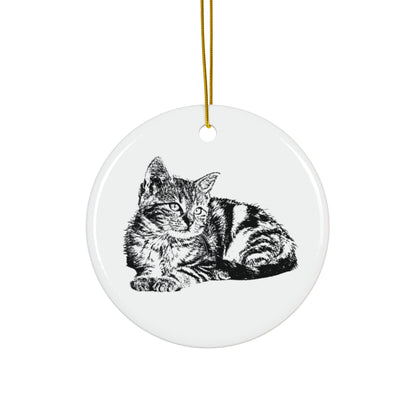 Round ceramic ornament with a black and white cat illustration on a white background