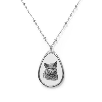 Teardrop-shaped pendant with a cat illustration on a silver chain against a white background