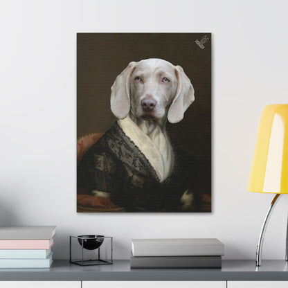 Framed portrait of a dog on a wall above a desk with books and a lamp.