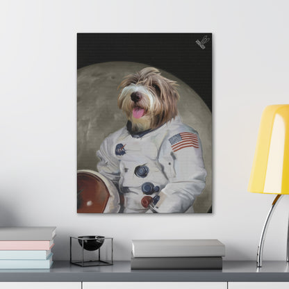 Framed artwork of a dog in an astronaut suit with a moon background on a wall above a desk.