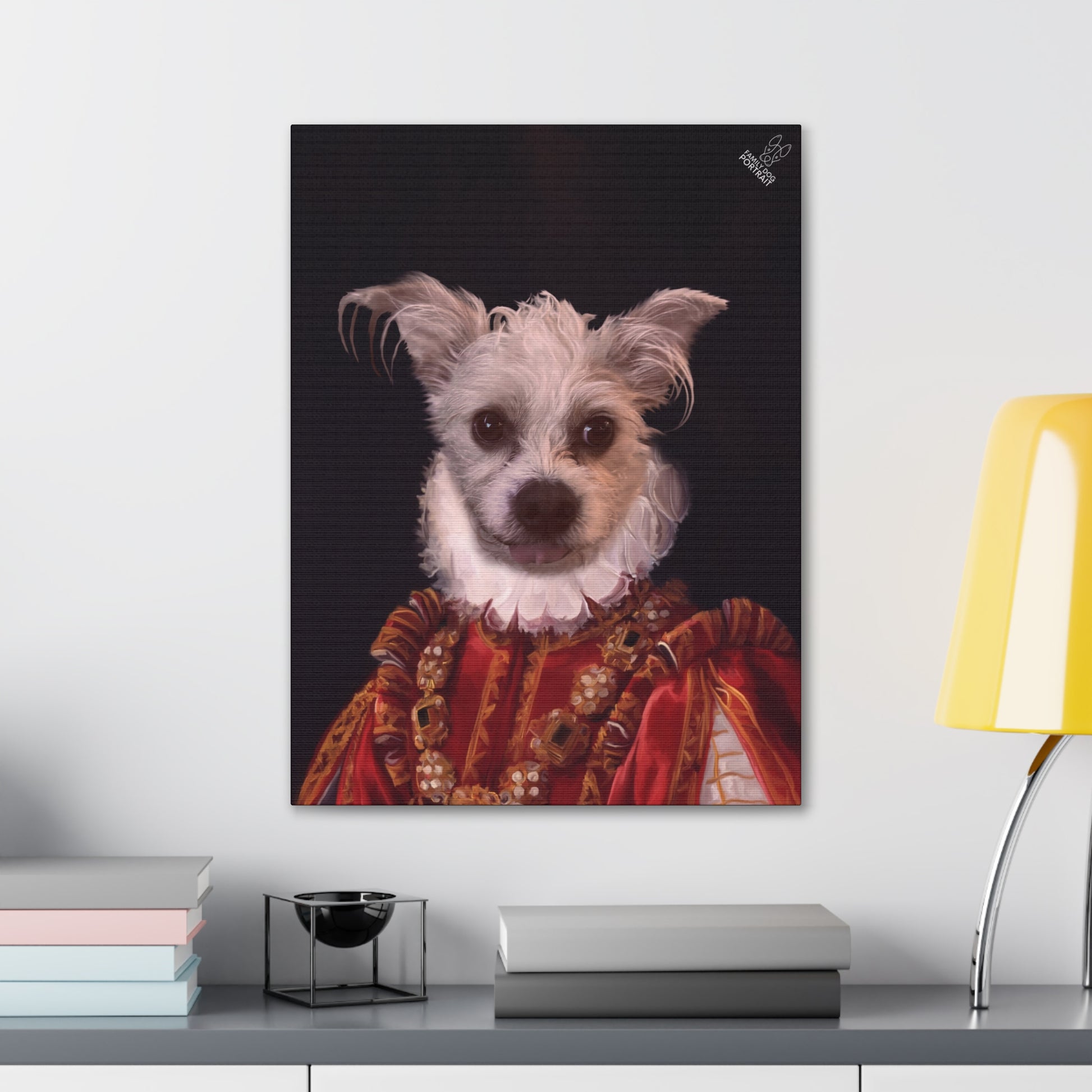 Framed portrait of a dog dressed in regal attire on a shelf with books and a lamp.