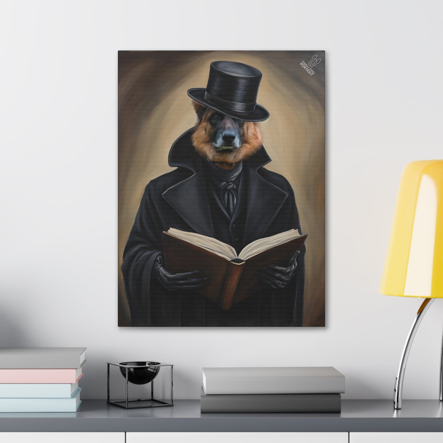Framed artwork of a dog in a coat and top hat reading a book on a wall above a desk.