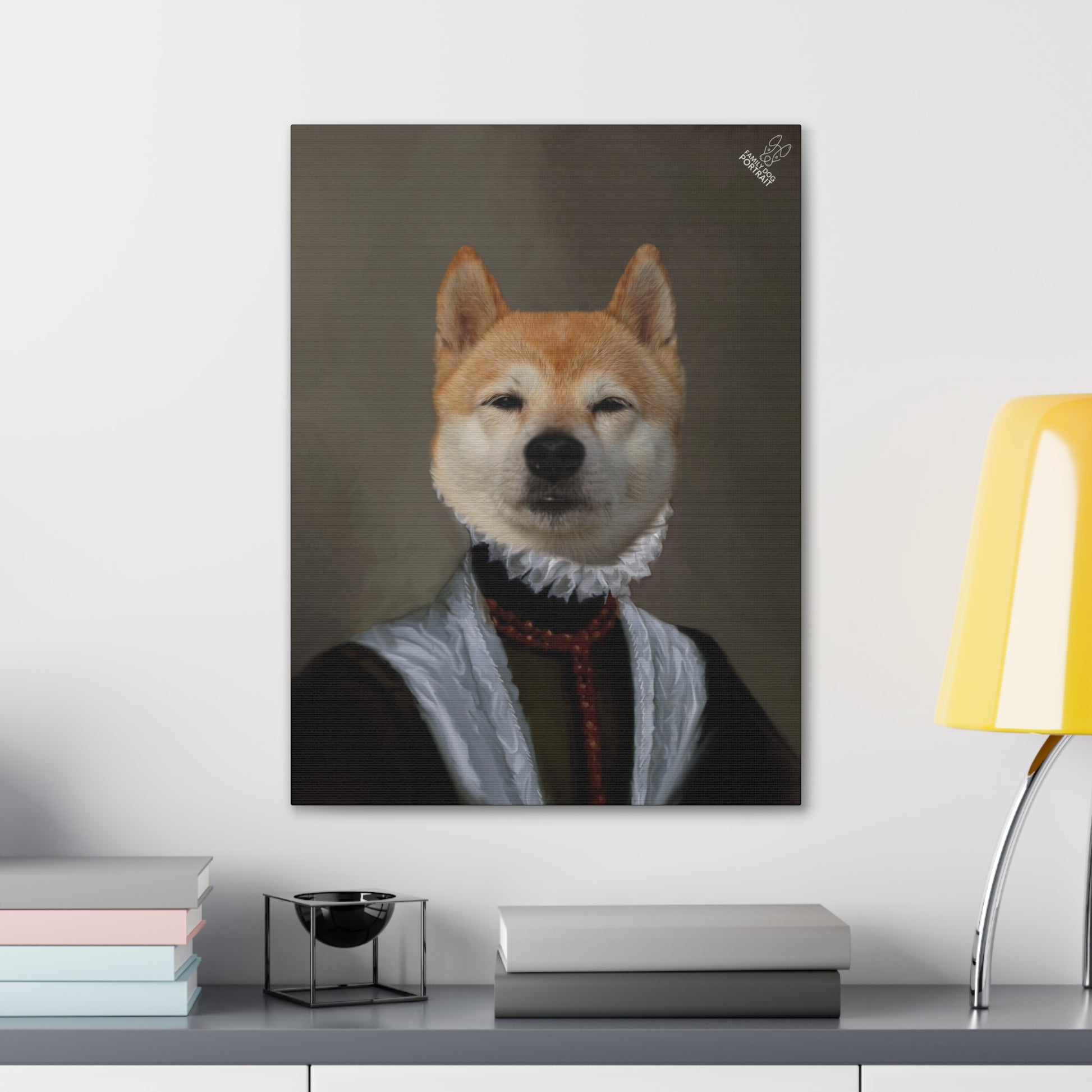 Framed portrait of a dog with a historical attire on a wall above a desk.