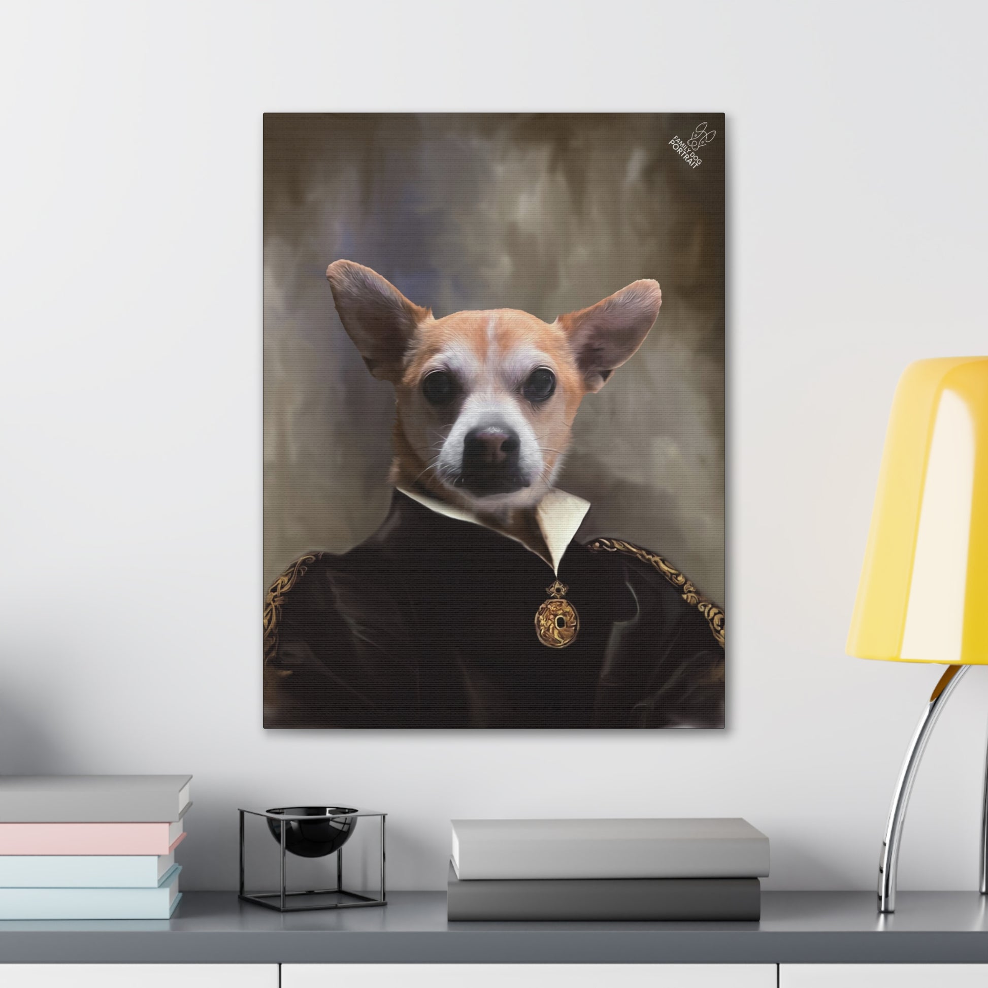 Framed portrait of a dog in formal attire on a wall above a desk with books and a lamp.